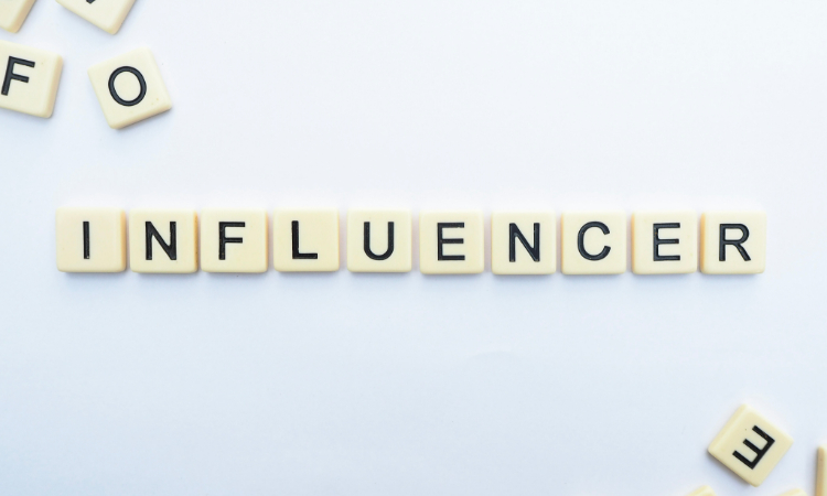 Small white tiles that spell out the word 'influencer'